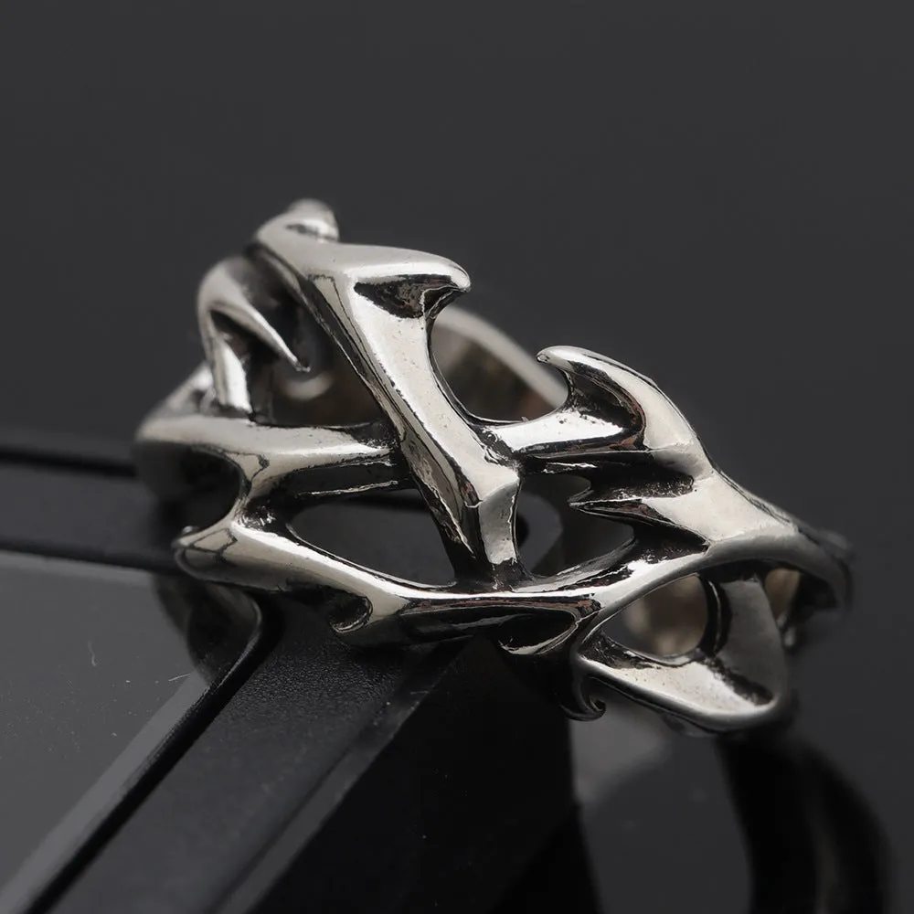 Copper men's ring with geometric thorn and flower design and adjustable band.