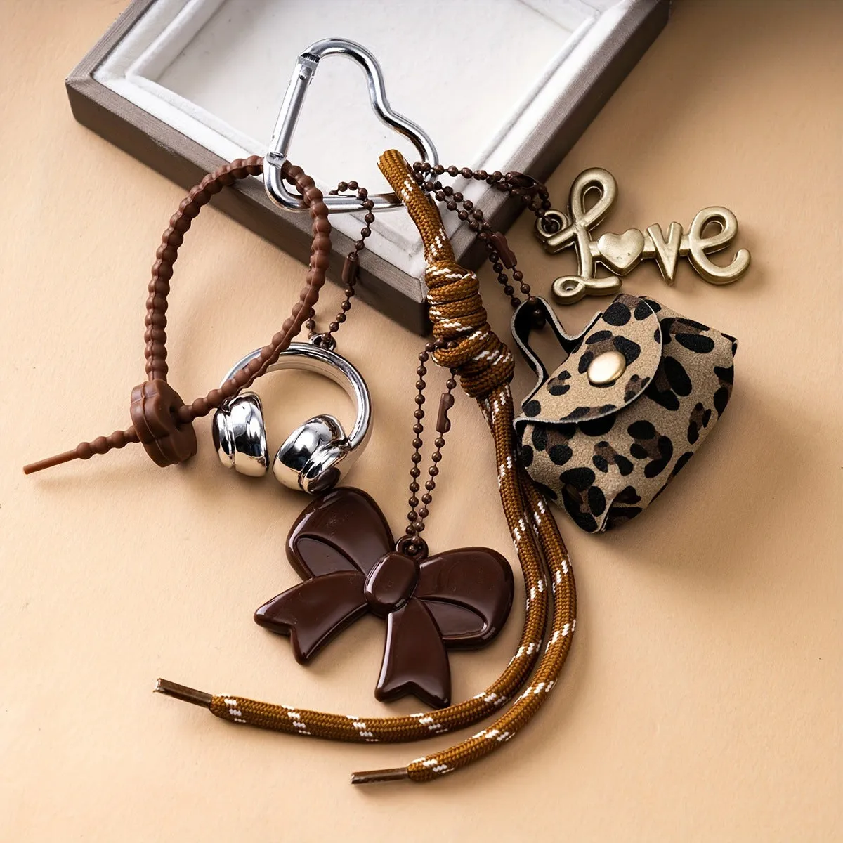 Fashion bow earphone Miu series braided rope bag pendant keychain in black with bow detail