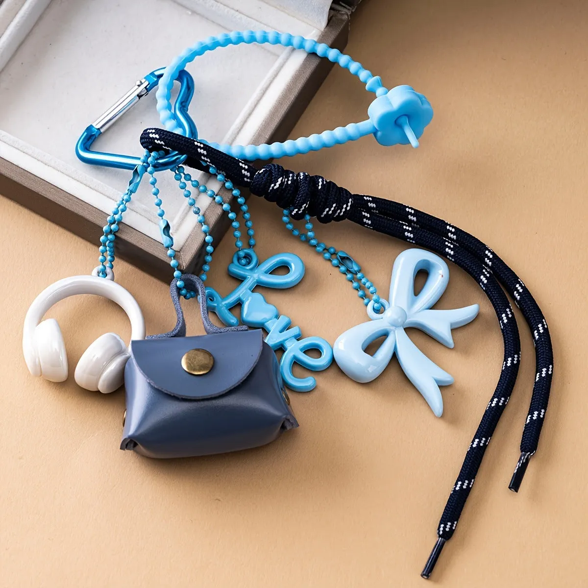 Fashion bow earphone Miu series braided rope bag pendant keychain in black with bow detail