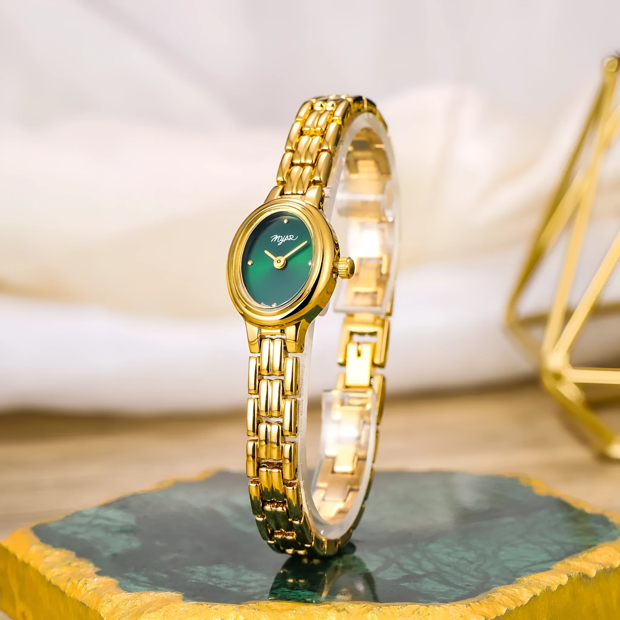 Oval mini women's vintage quartz watch with gold alloy case, white dial, and jewellery buckle