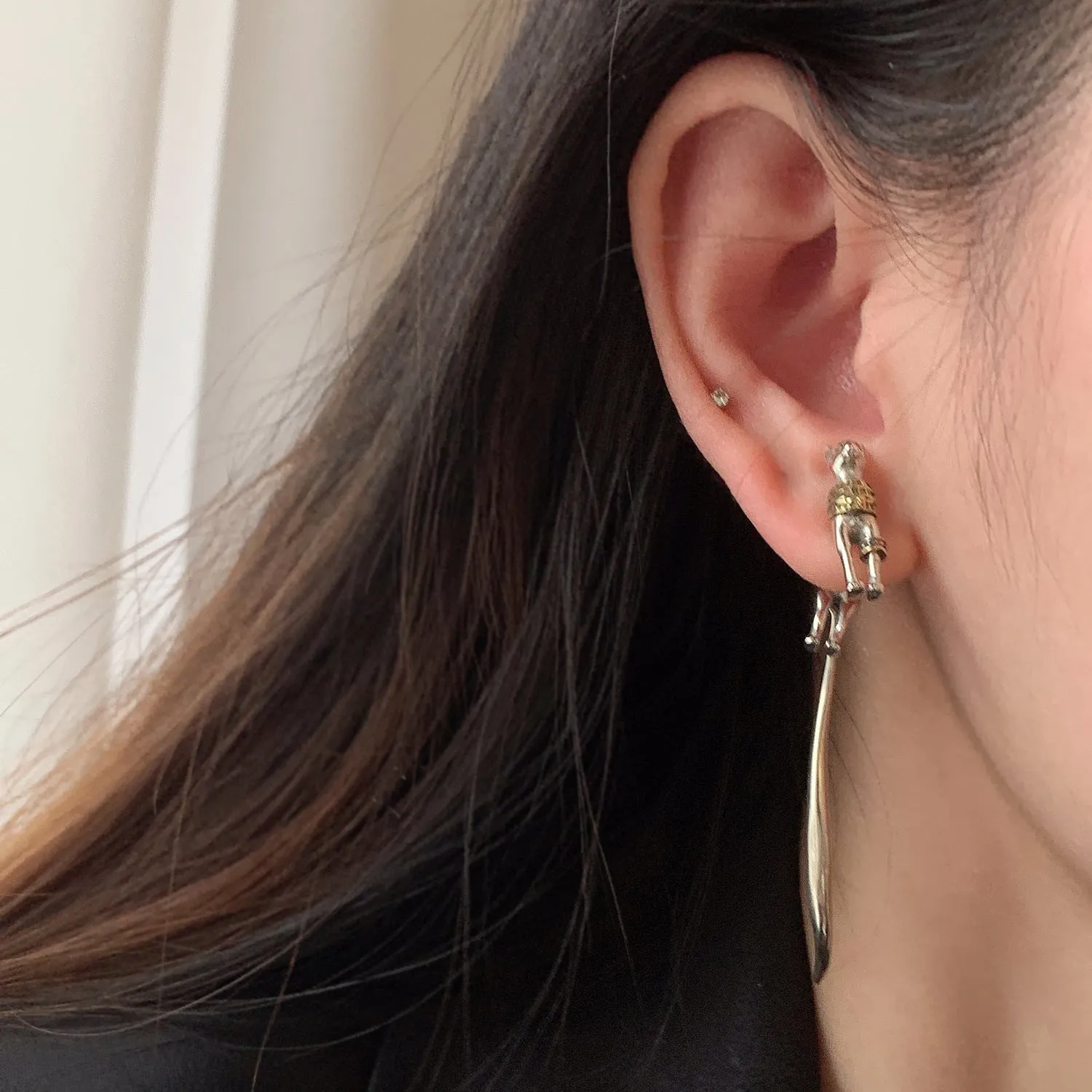 Single copper earring with pharaoh cat shape, gold and silver two-tone copper plated finish, colour separation design