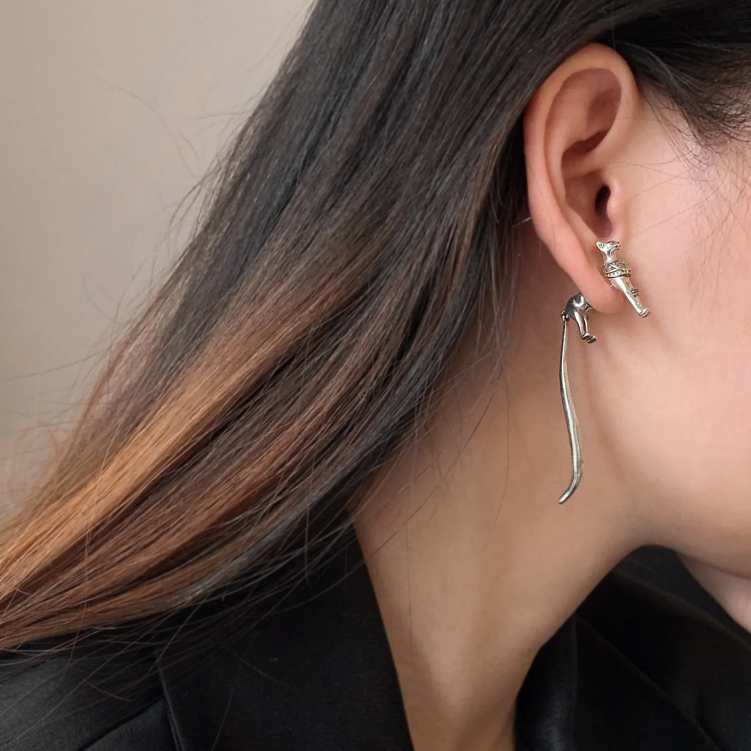 Single copper earring with pharaoh cat shape, gold and silver two-tone copper plated finish, colour separation design
