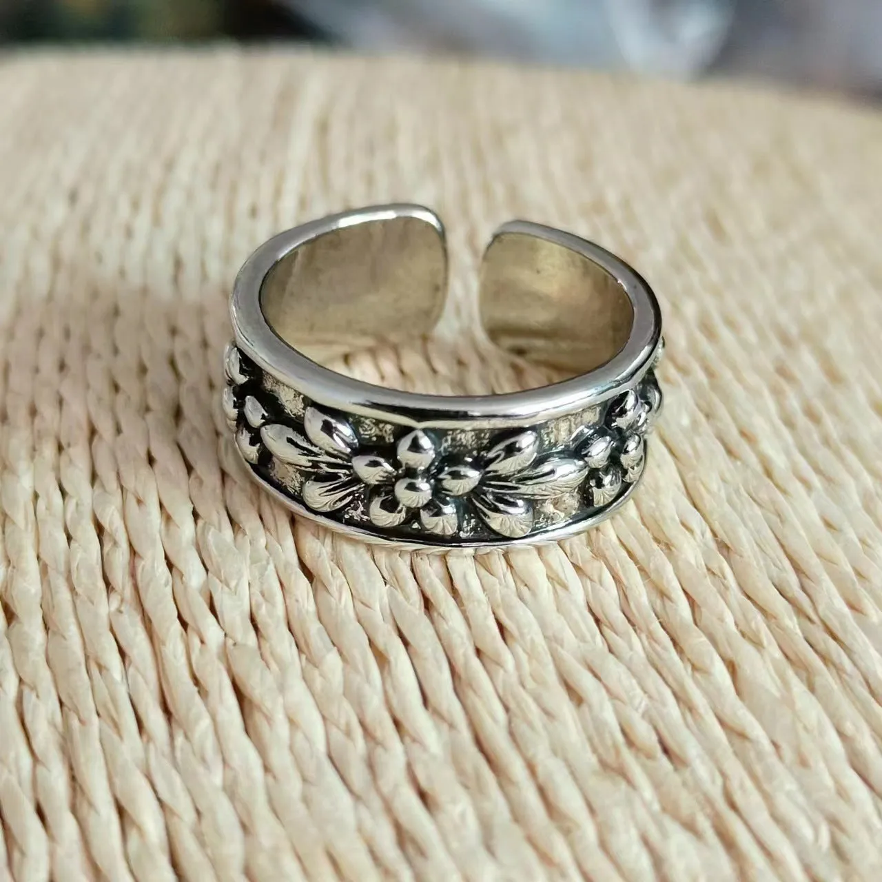 Vintage antique silver gold flower open ring with camellia floral design on a neutral background