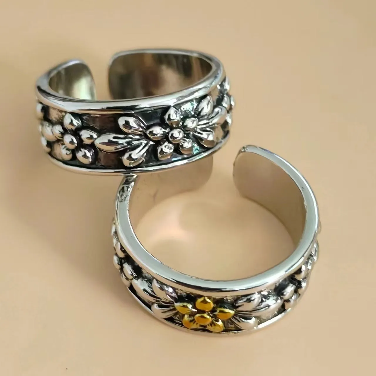 Vintage antique silver gold flower open ring with camellia floral design on a neutral background