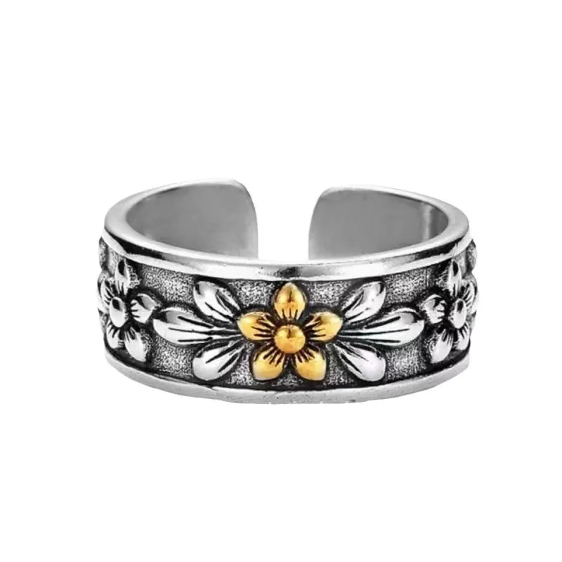 Vintage antique silver gold flower open ring with camellia floral design on a neutral background