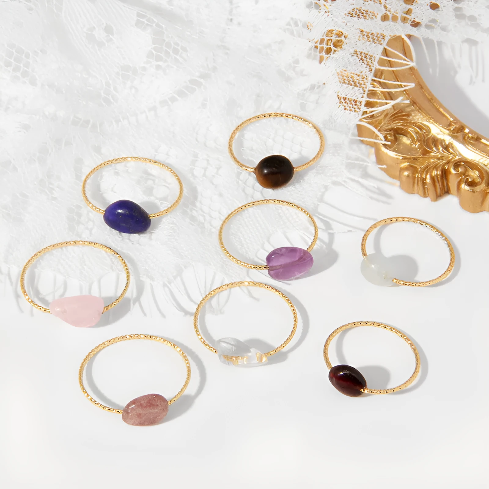 Geometric silver-tone ring with a coloured agate stone in a niche design, side view.