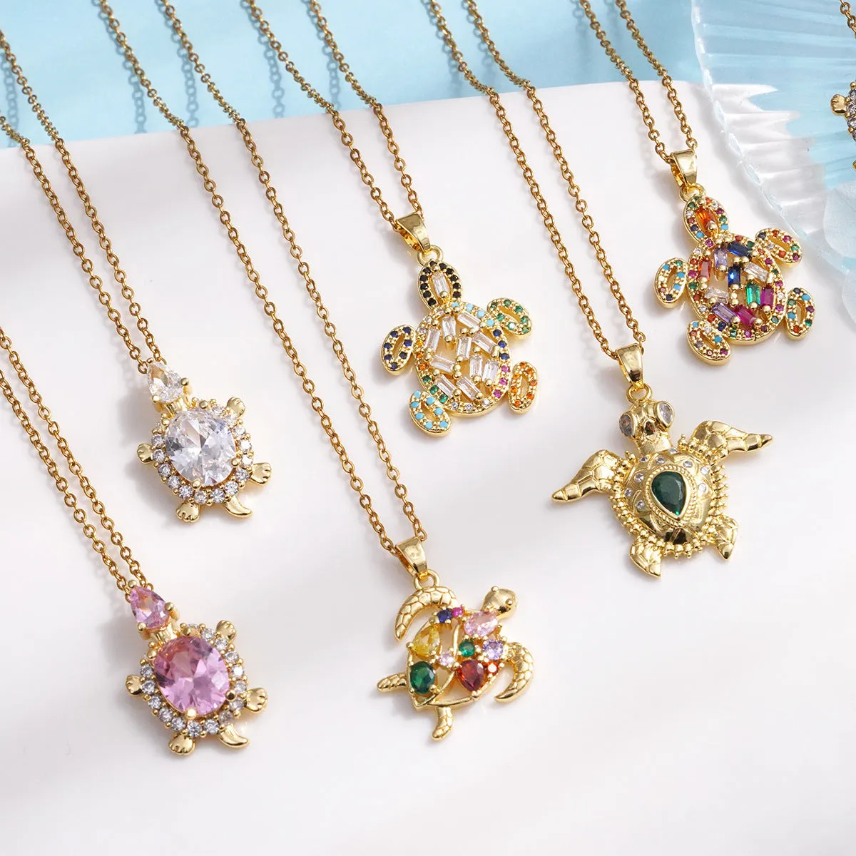 Gold-plated copper sea turtle necklace with zirconium accents and mixed gemstone inlay, O-link chain, light luxury style for women