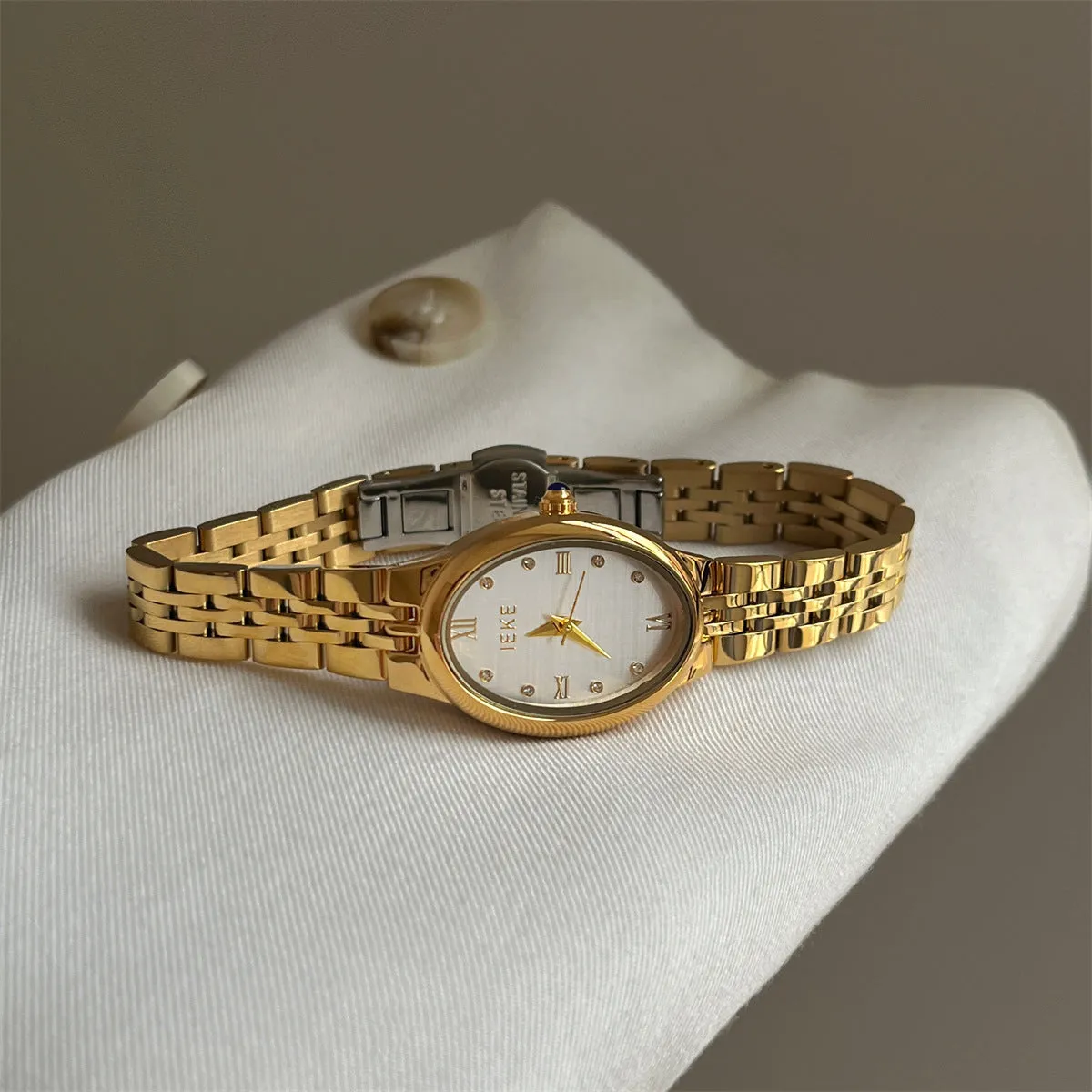 Oval dial ladies watch with dot markers, 37mm, gold strap and gold face