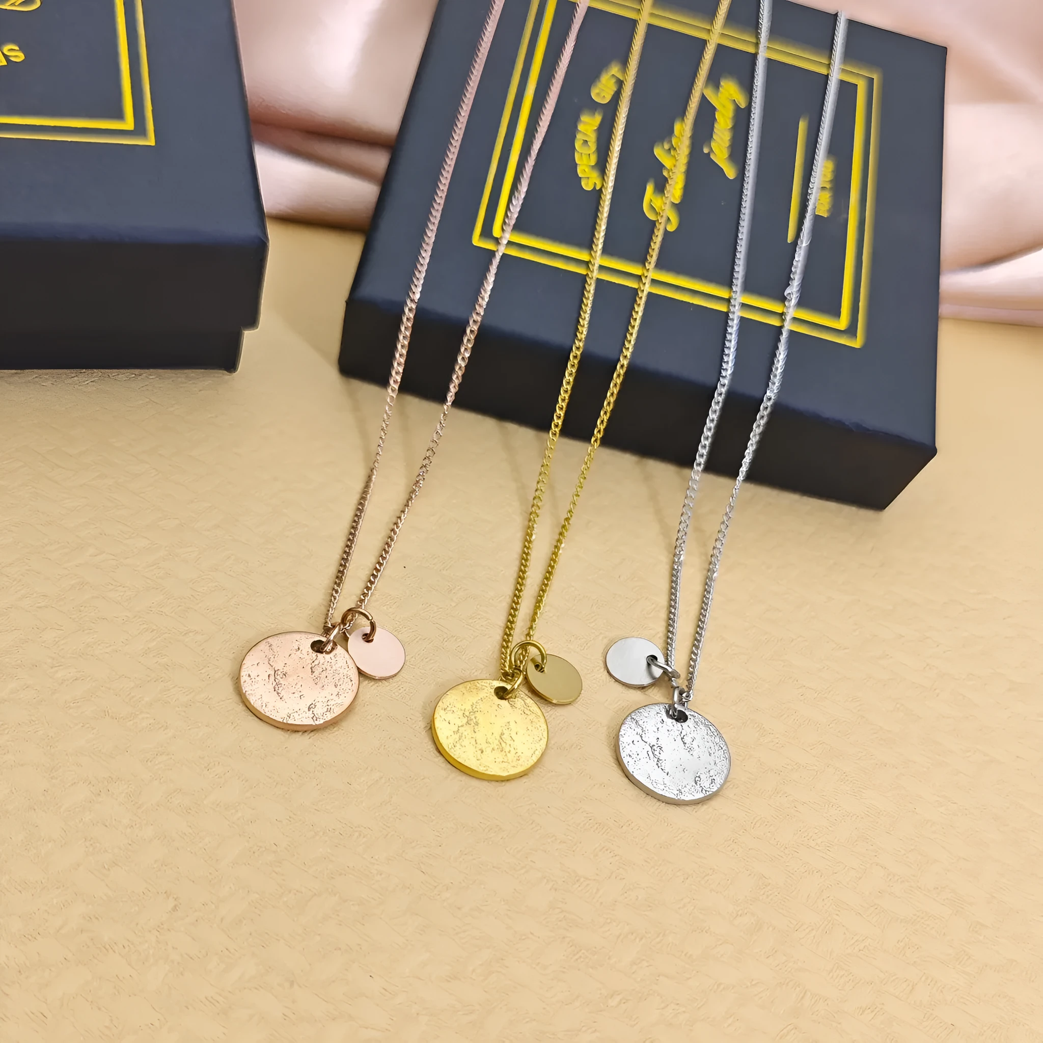 Round coin pendant necklace in gold finish on white background, adjustable 41-50cm stainless steel side chain