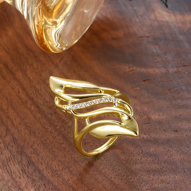 Gold-coloured copper women's ring with exaggerated curve design on finger