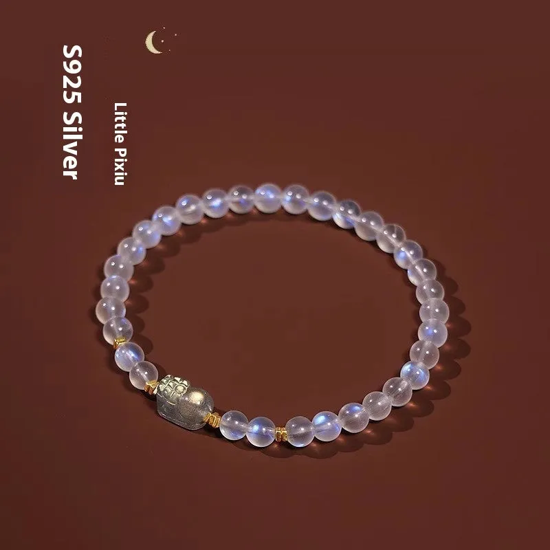 Close-up of a women's moonstone bracelet with zodiac animal design in a traditional Chinese style.