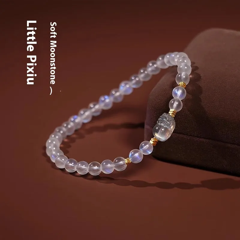 Close-up of a women's moonstone bracelet with zodiac animal design in a traditional Chinese style.