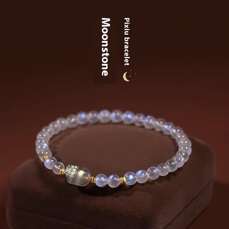 Close-up of a women's moonstone bracelet with zodiac animal design in a traditional Chinese style.