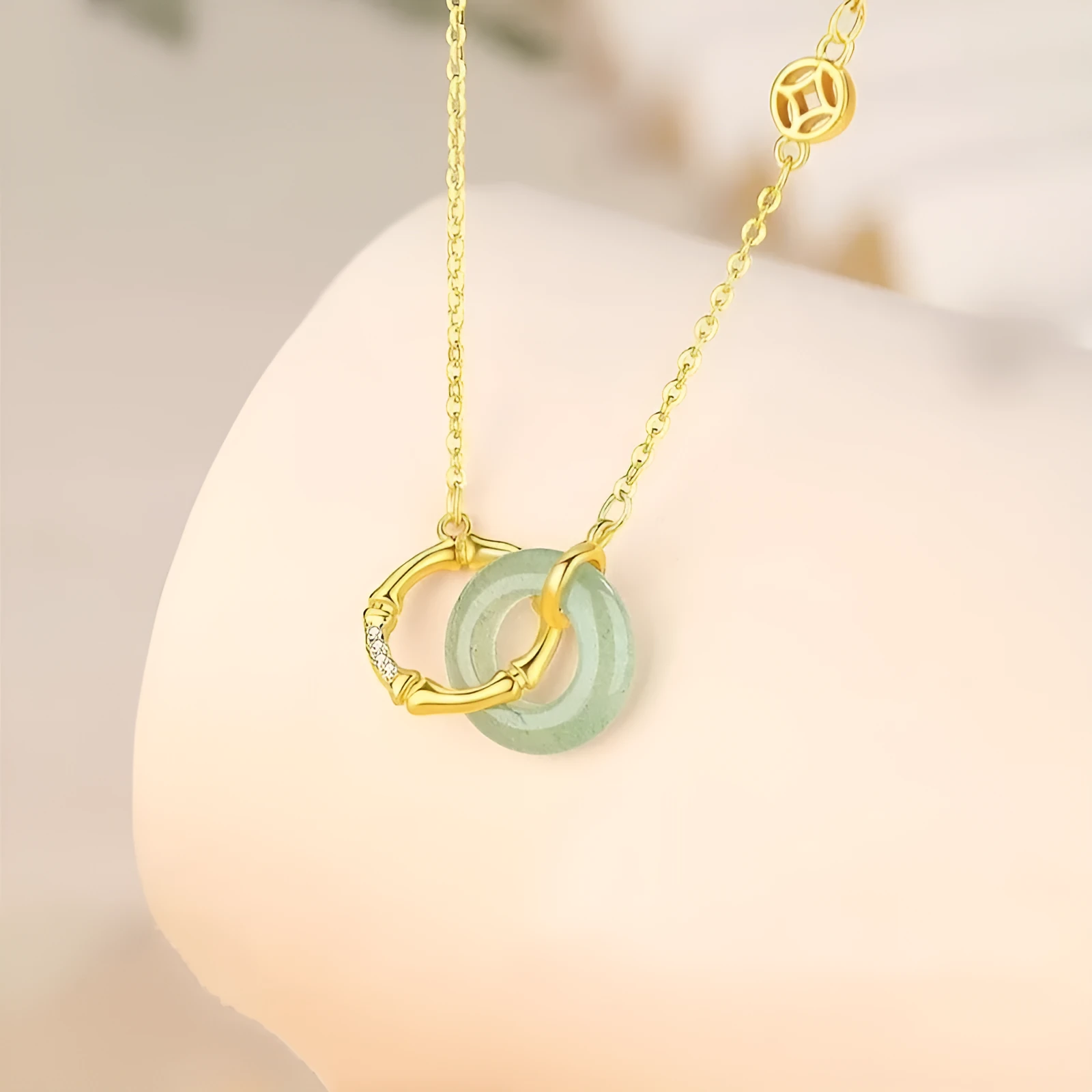 Sterling silver bamboo joint peace buckle necklace with geometric O-ring chain on grey background