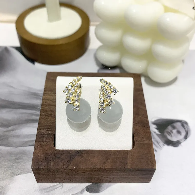 Curved zircon pearl earrings available in golden cats eye stone, golden white pearl, and silver white pearl