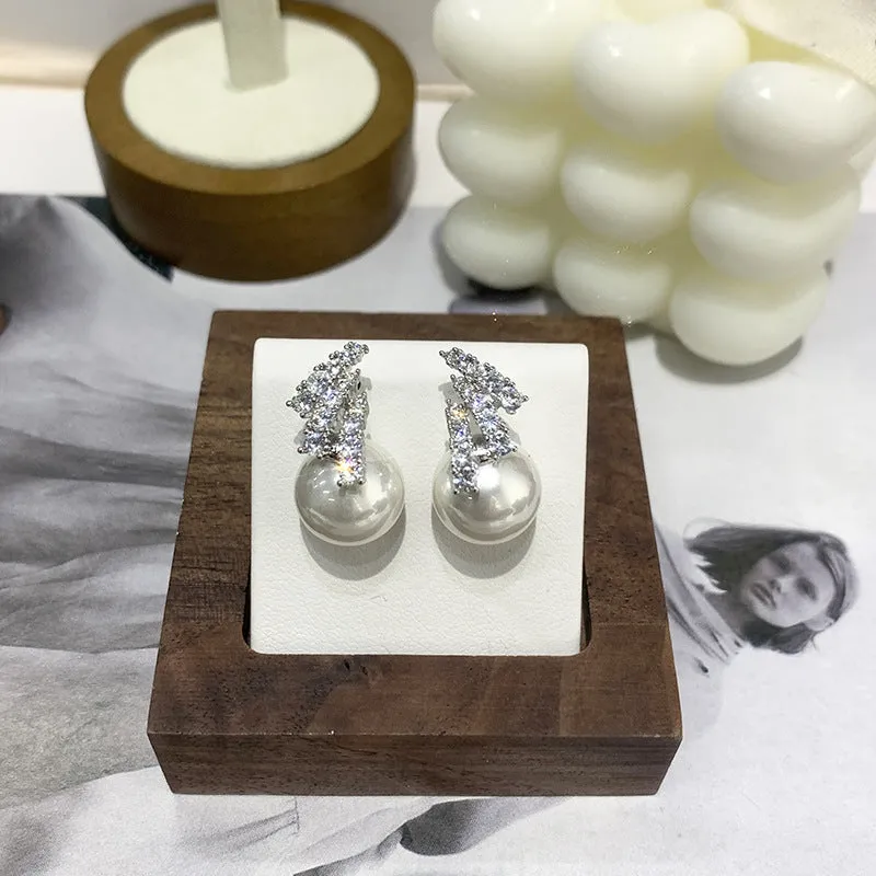 Curved zircon pearl earrings available in golden cats eye stone, golden white pearl, and silver white pearl