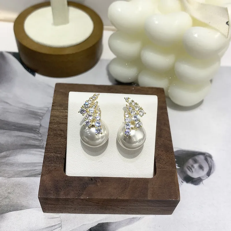 Curved zircon pearl earrings available in golden cats eye stone, golden white pearl, and silver white pearl