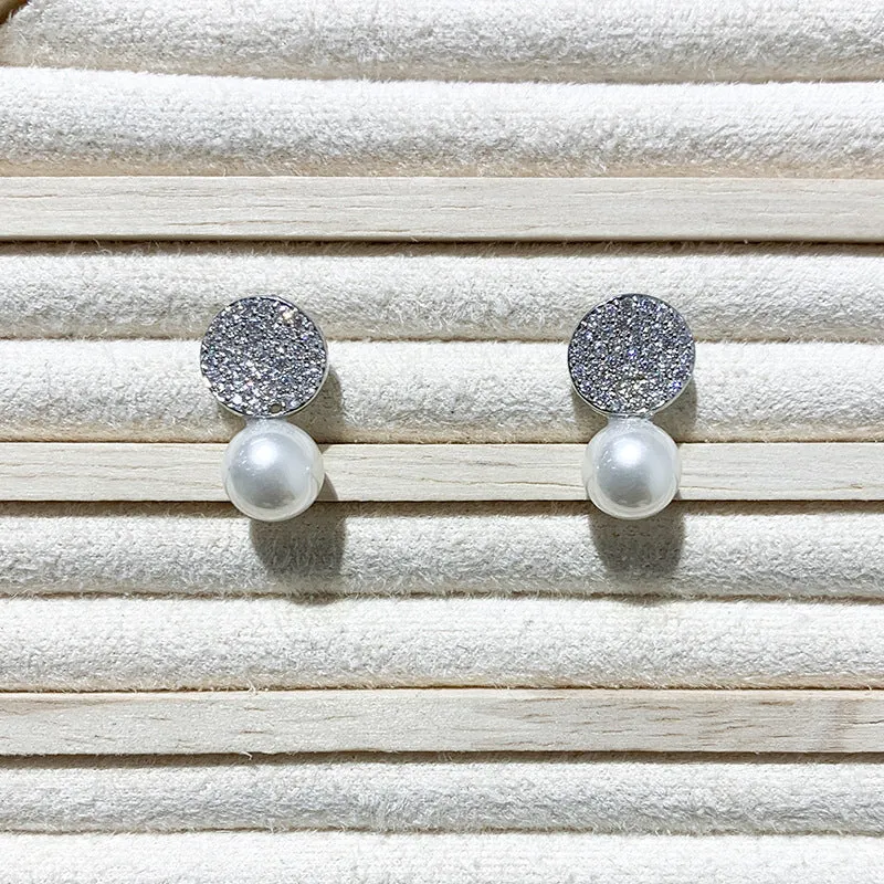 Round diamond studded pearl earrings in gold finish with post back closure