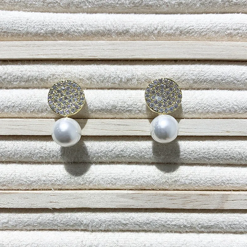 Round diamond studded pearl earrings in gold finish with post back closure