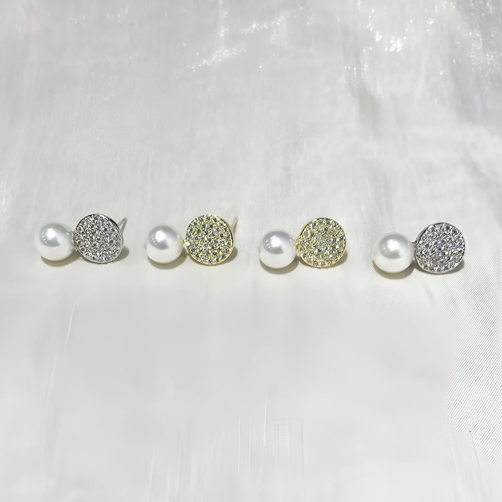 Round diamond studded pearl earrings in gold finish with post back closure