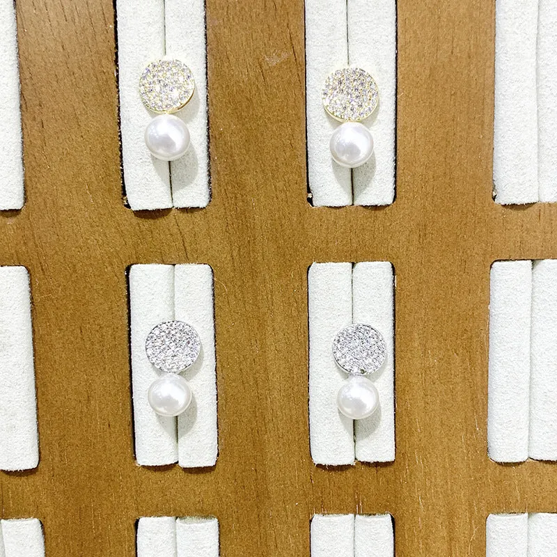 Round diamond studded pearl earrings in gold finish with post back closure