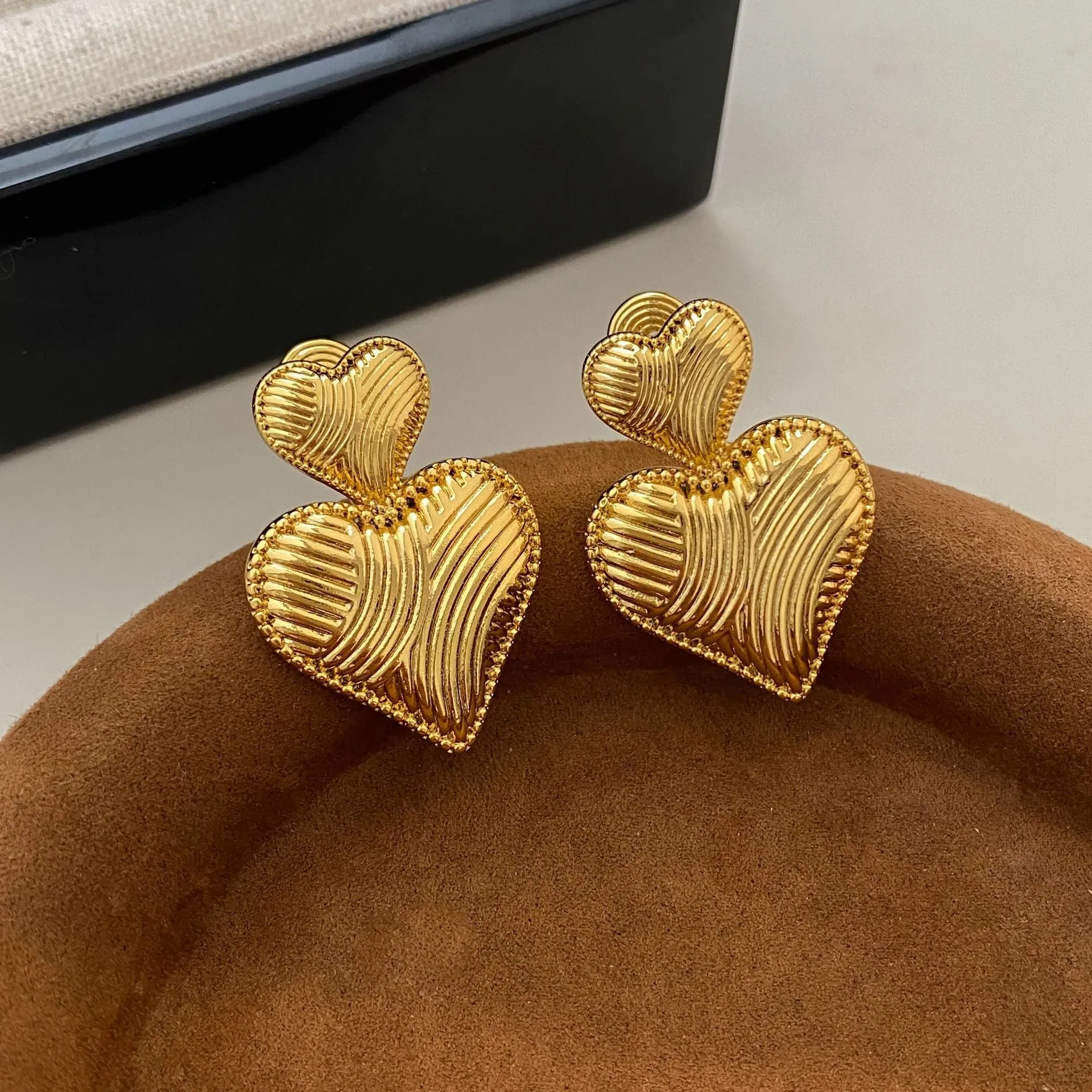 Double heart copper earrings with electroplated finish, available as ear clips or ear studs
