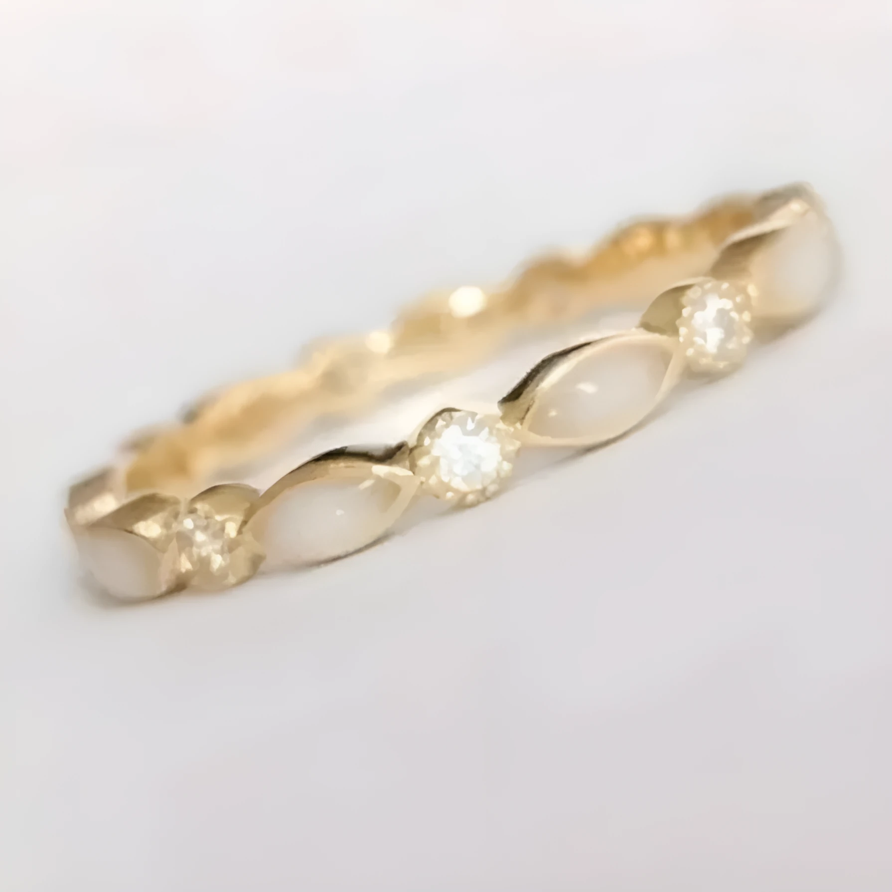 French golden opal open adjustable ring in gold alloy with geometric shape on a white background