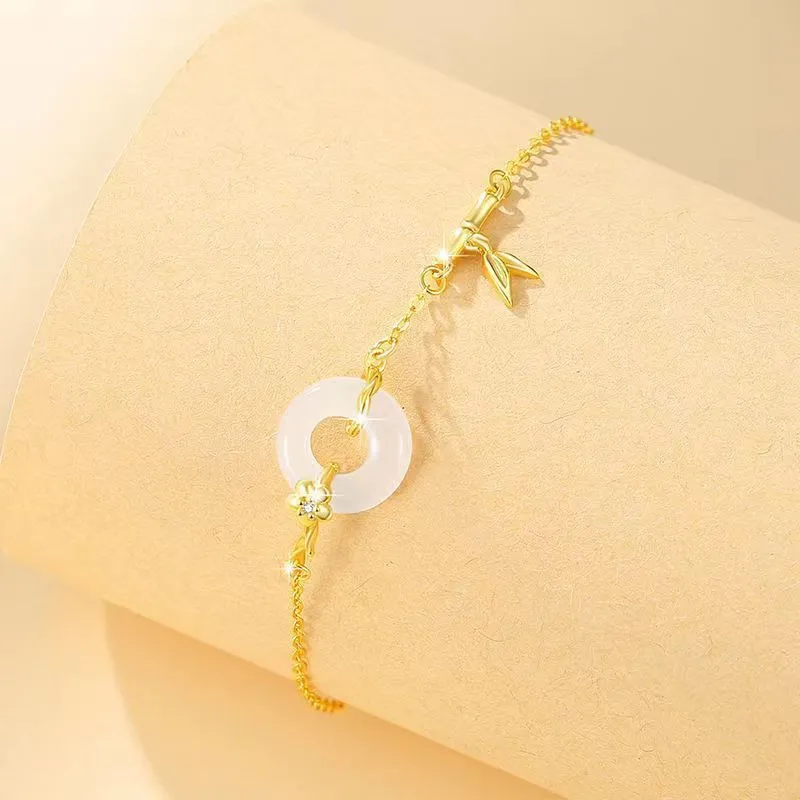 Gold tone women's bracelet with white chalcedony stone and adjustable peace symbol buckle closure