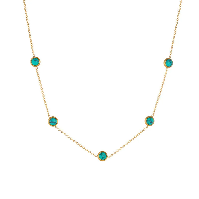 Round turquoise stainless steel earrings and necklace set on display