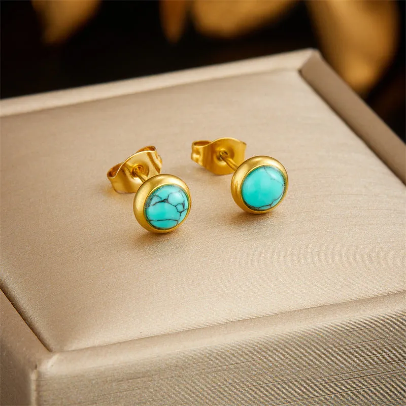 Round turquoise stainless steel earrings and necklace set on display