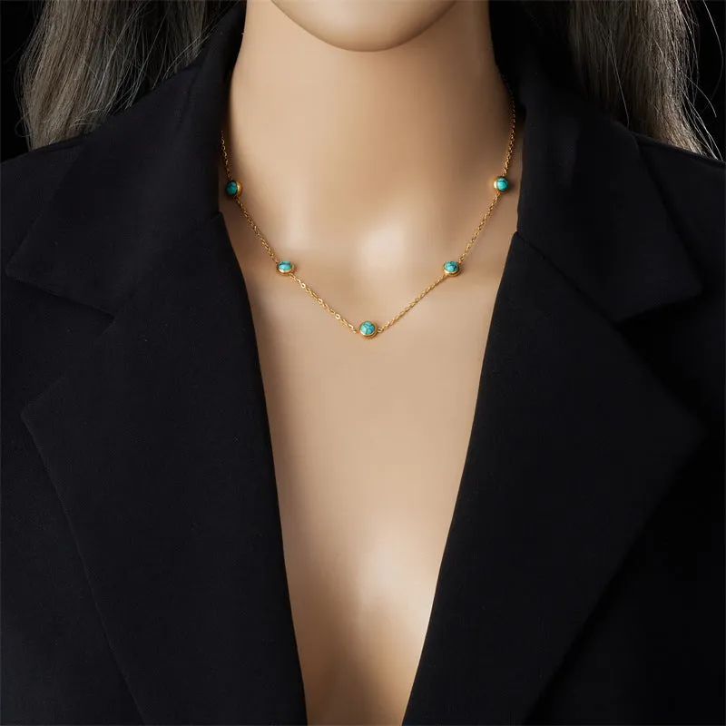 Round turquoise stainless steel earrings and necklace set on display