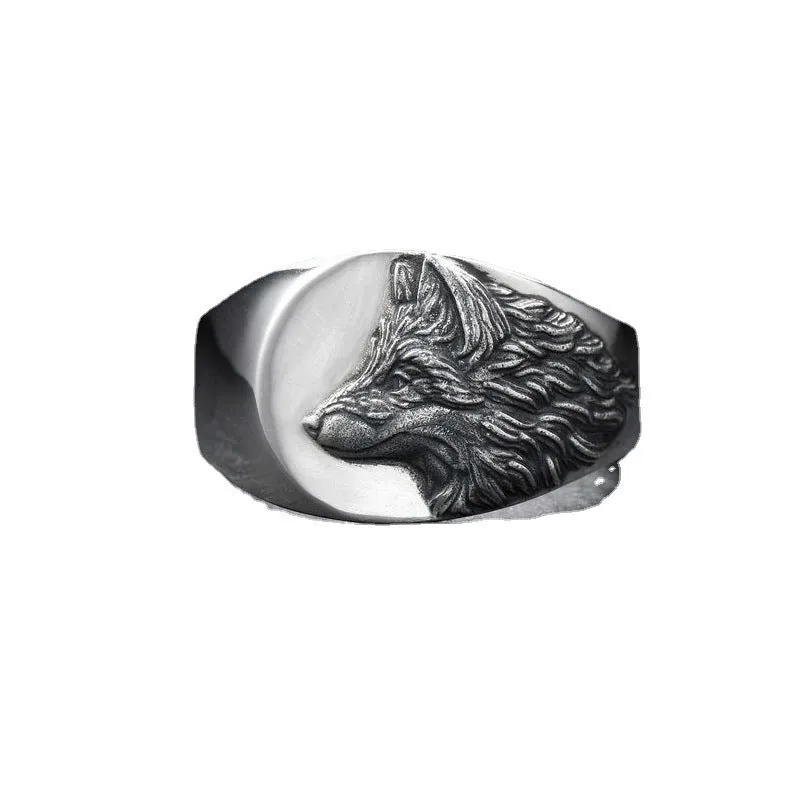 Silver men's ring with a geometric wolf design on a black background.