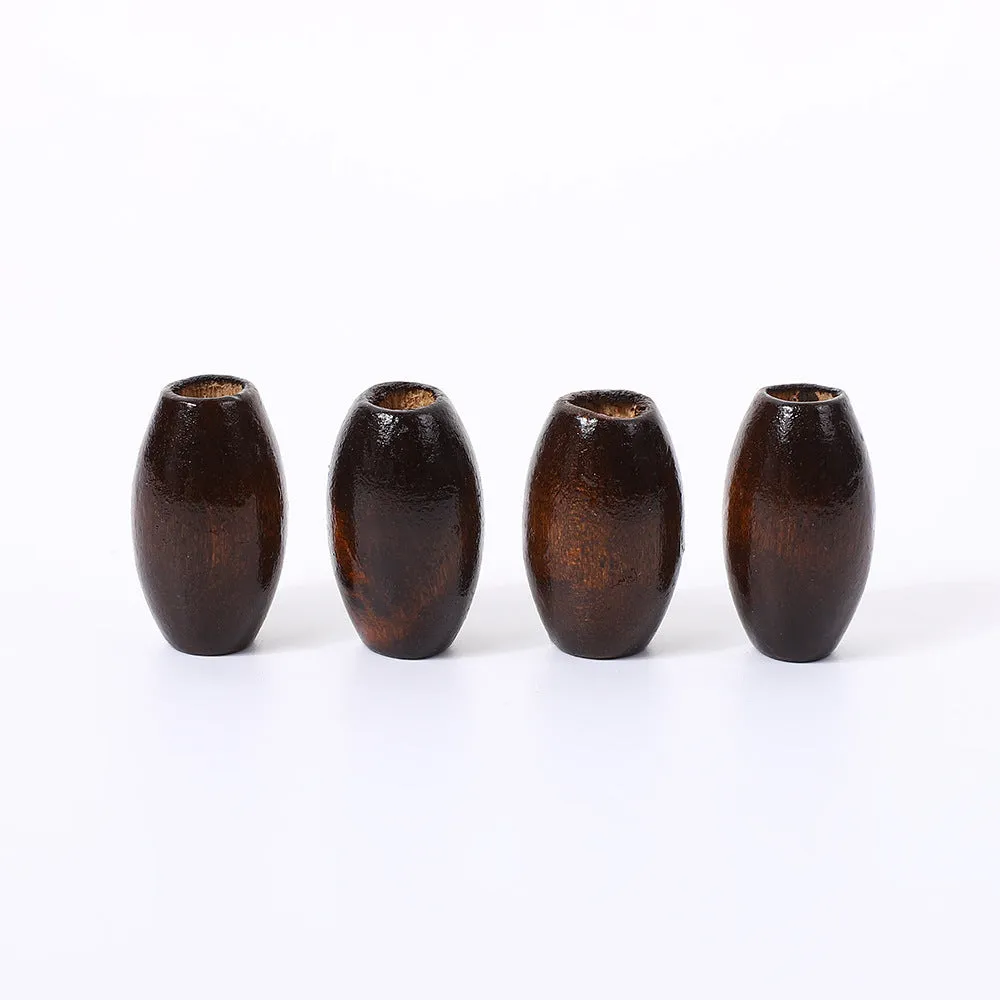 Dark coffee coloured wooden oval bead with M-shaped raised design, 25mm size