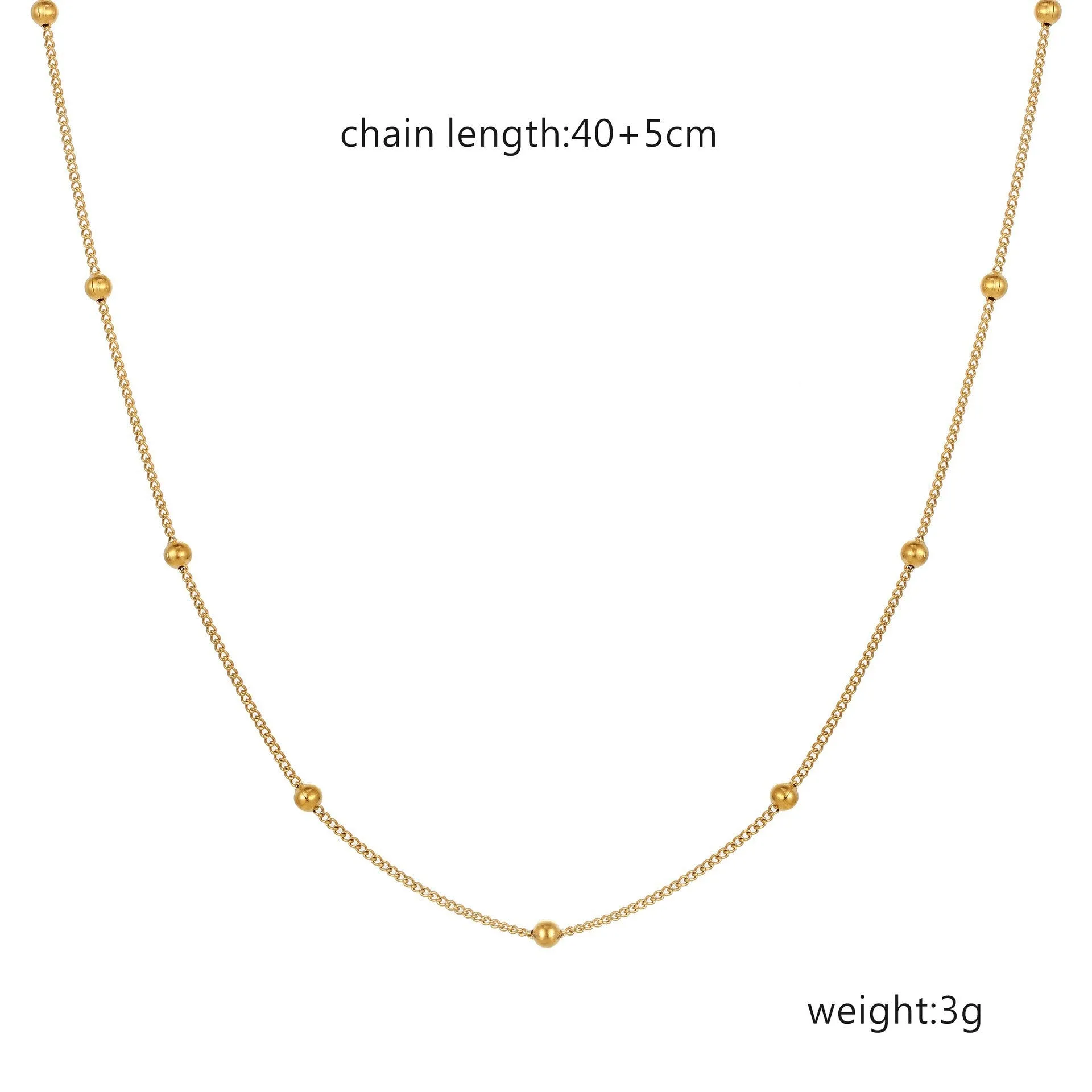 Women's stainless steel necklace with 18K gold hollow round pendant and O-link chain on neutral background