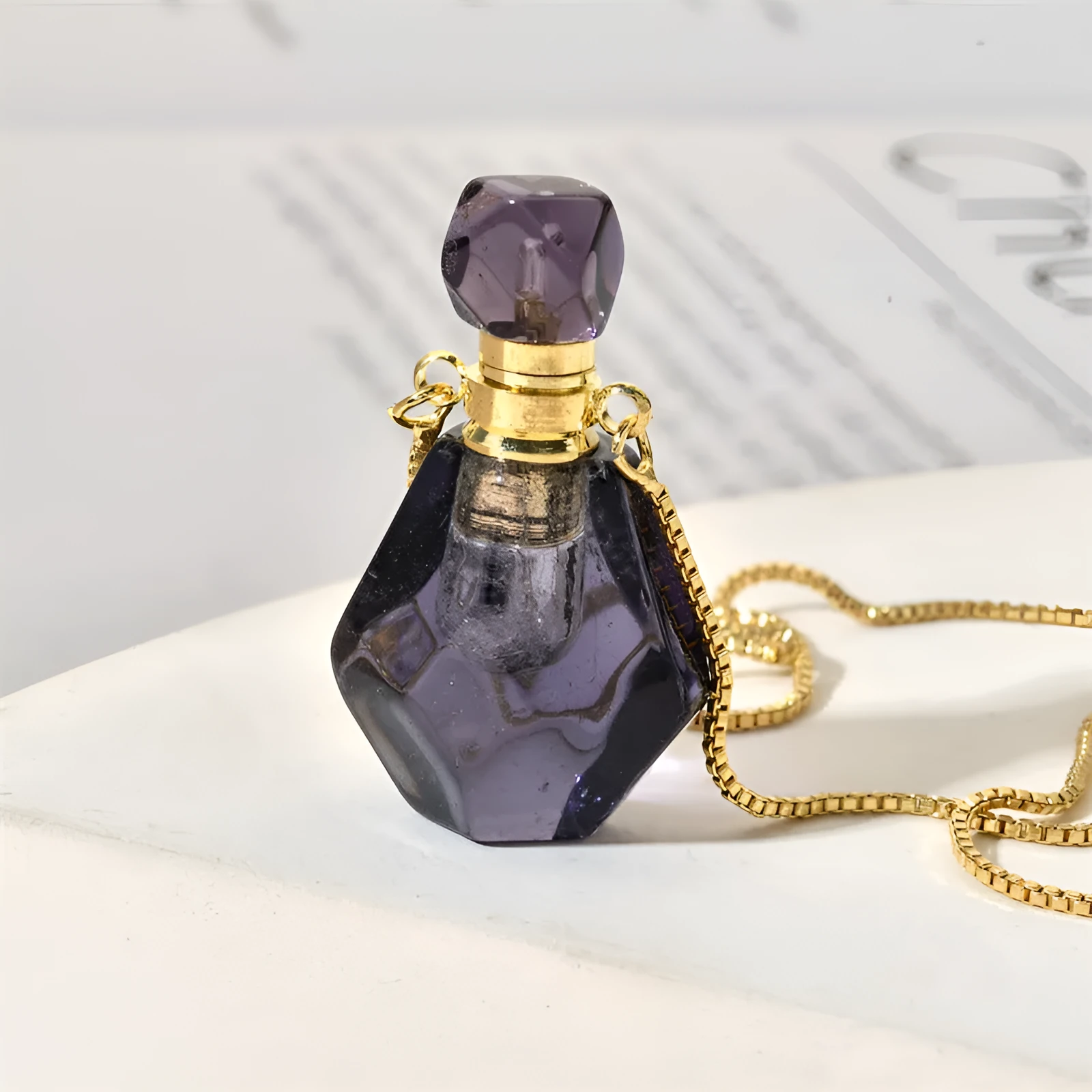 Semi-precious amethyst perfume bottle pendant necklace with alloy chain on neutral background