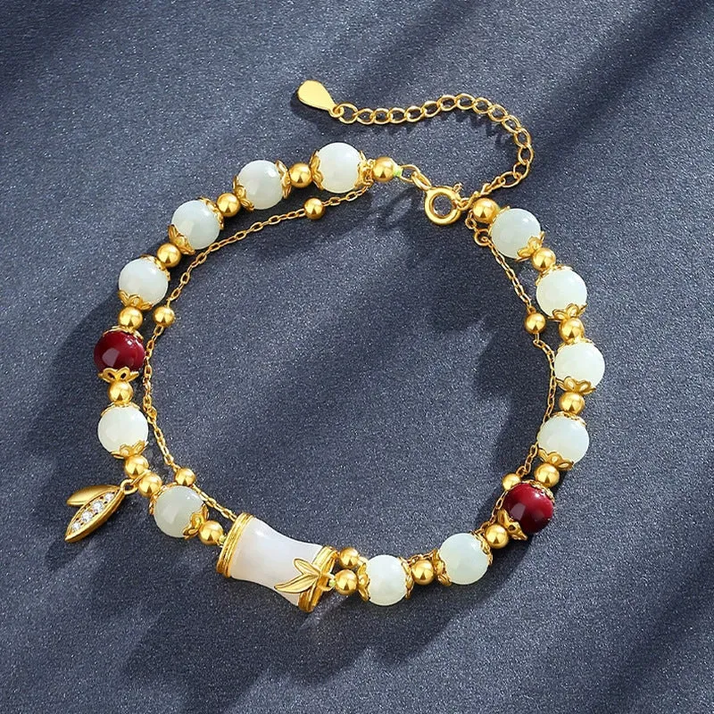 Bamboo style bracelet with electroplated coloured glass beads in a Ruyi flower design.