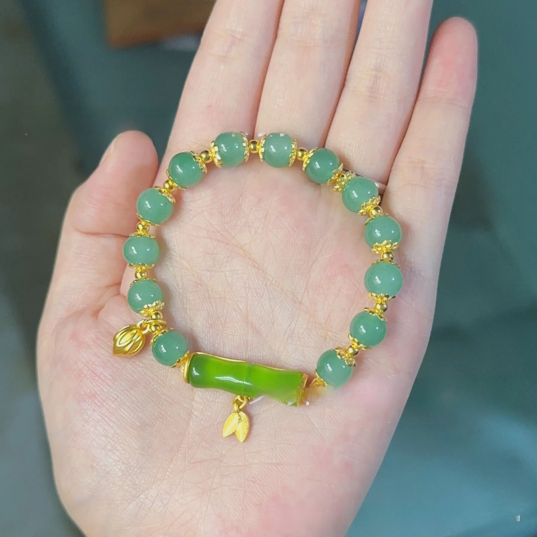 Bamboo style bracelet with electroplated coloured glass beads in a Ruyi flower design.