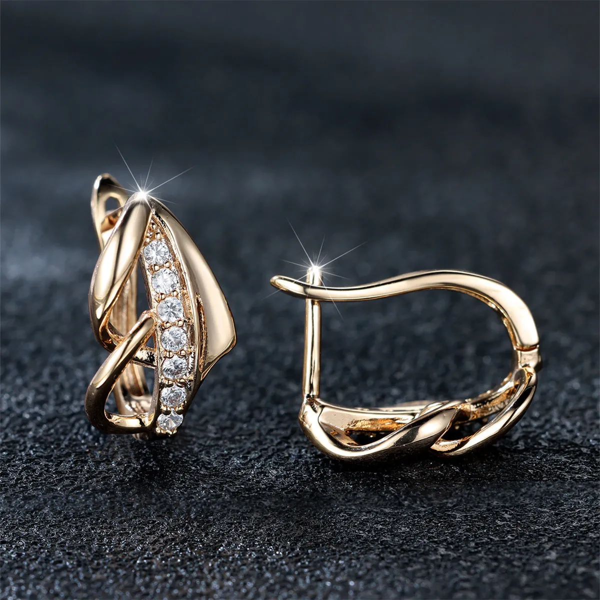 Copper geometric arrow ear clip in champagne gold with white diamond accent