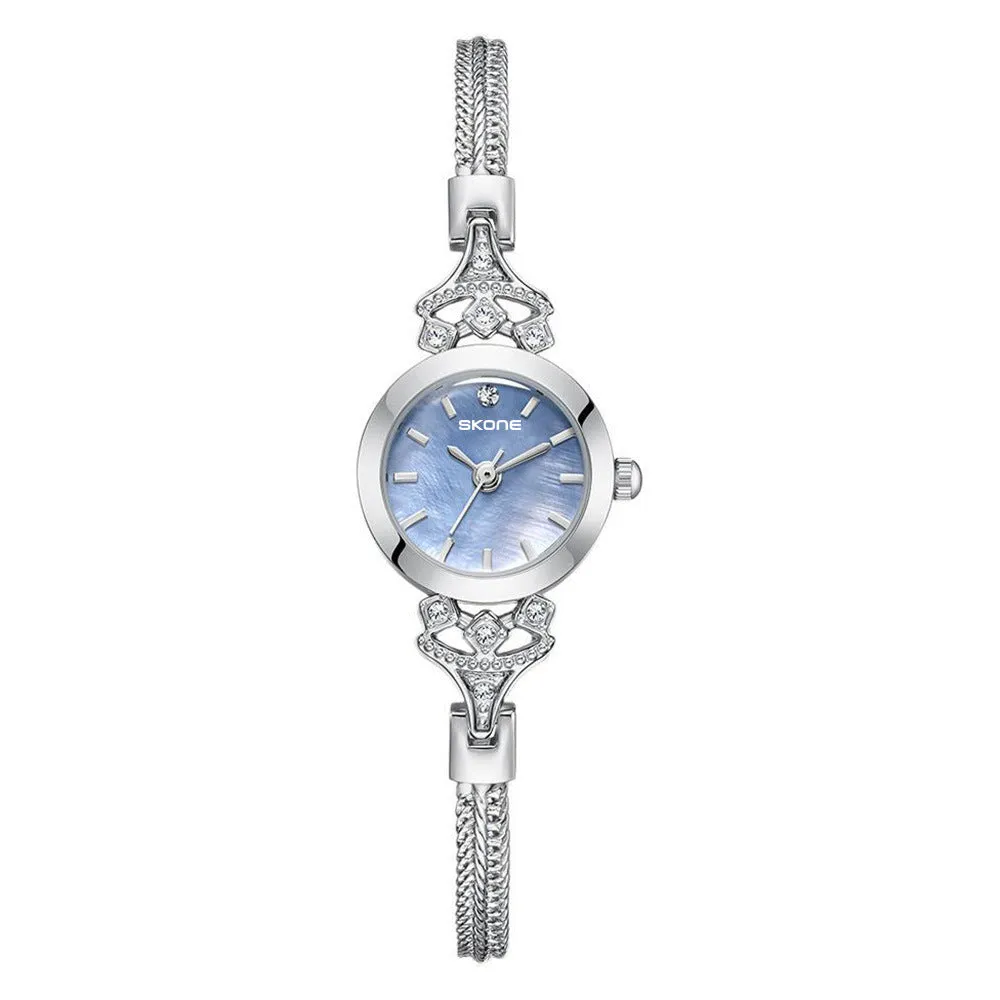 Women's quartz watch with gold white face and slim 8mm profile.