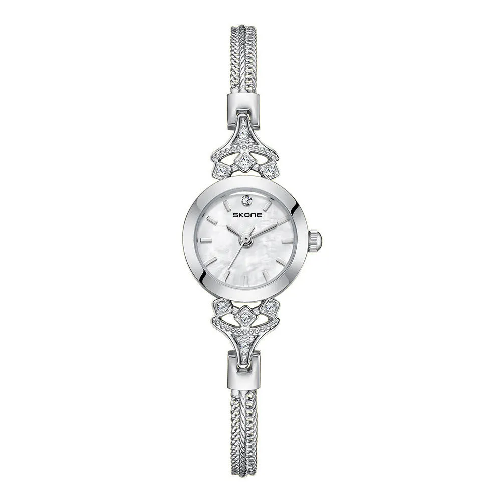 Women's quartz watch with gold white face and slim 8mm profile.