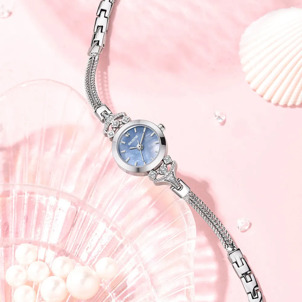 Women's quartz watch with gold white face and slim 8mm profile.