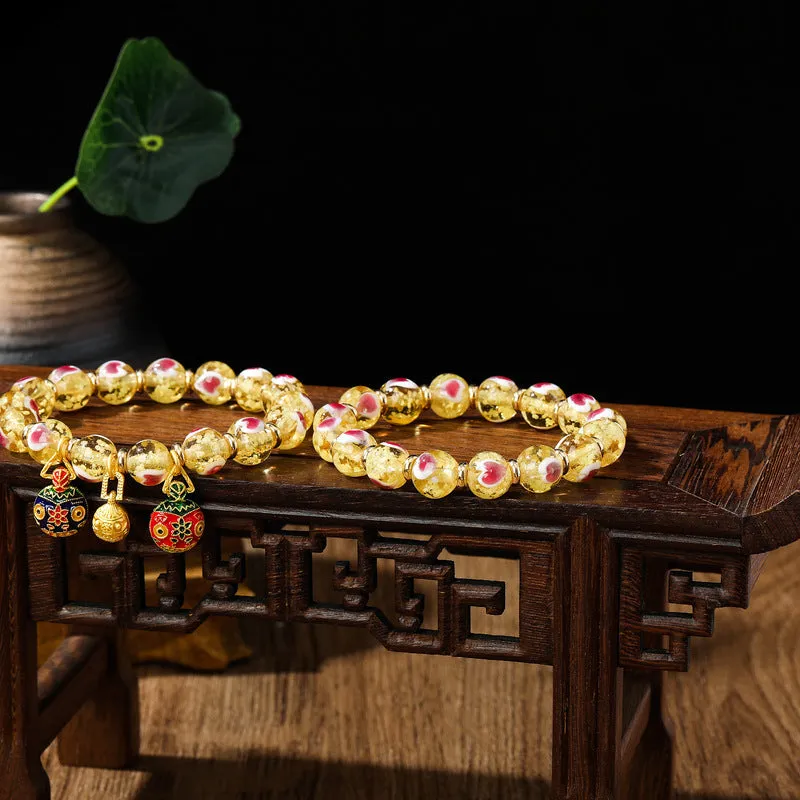 Handmade heart-shaped glass bead bracelet with ancient fluorescent glaze and swallowing gold beast design