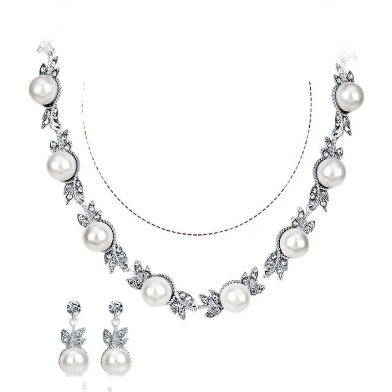 Three-piece jewellery set with rhinestone and pearl necklace, earrings, and bracelet in silver finish