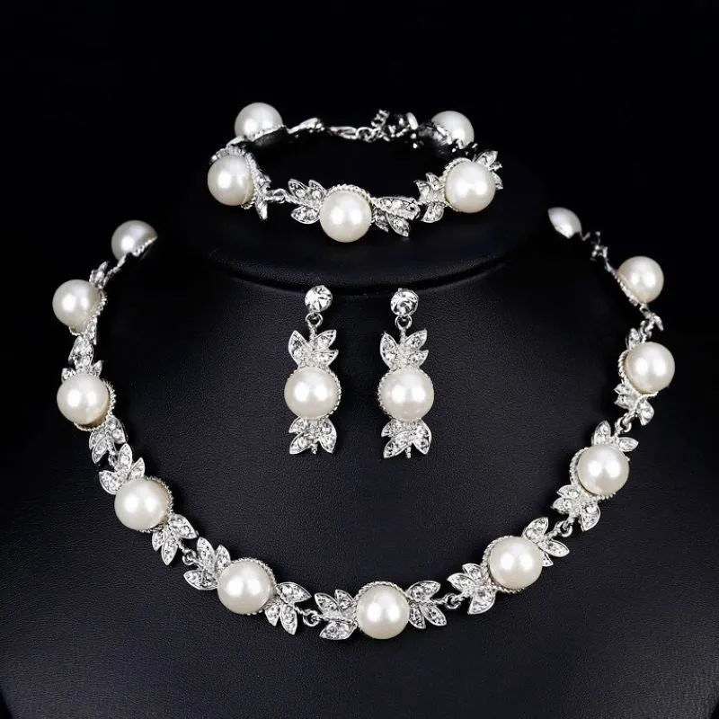Three-piece jewellery set with rhinestone and pearl necklace, earrings, and bracelet in silver finish