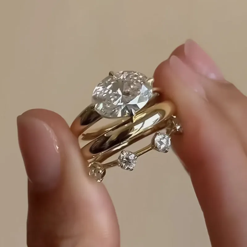 Gold electroplated minimalist ring with a row of small diamonds on silver band
