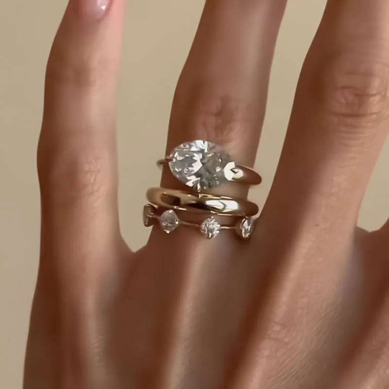 Gold electroplated minimalist ring with a row of small diamonds on silver band