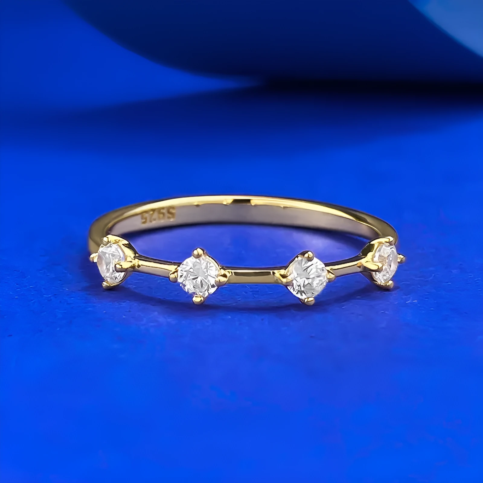 Gold electroplated minimalist ring with a row of small diamonds on silver band