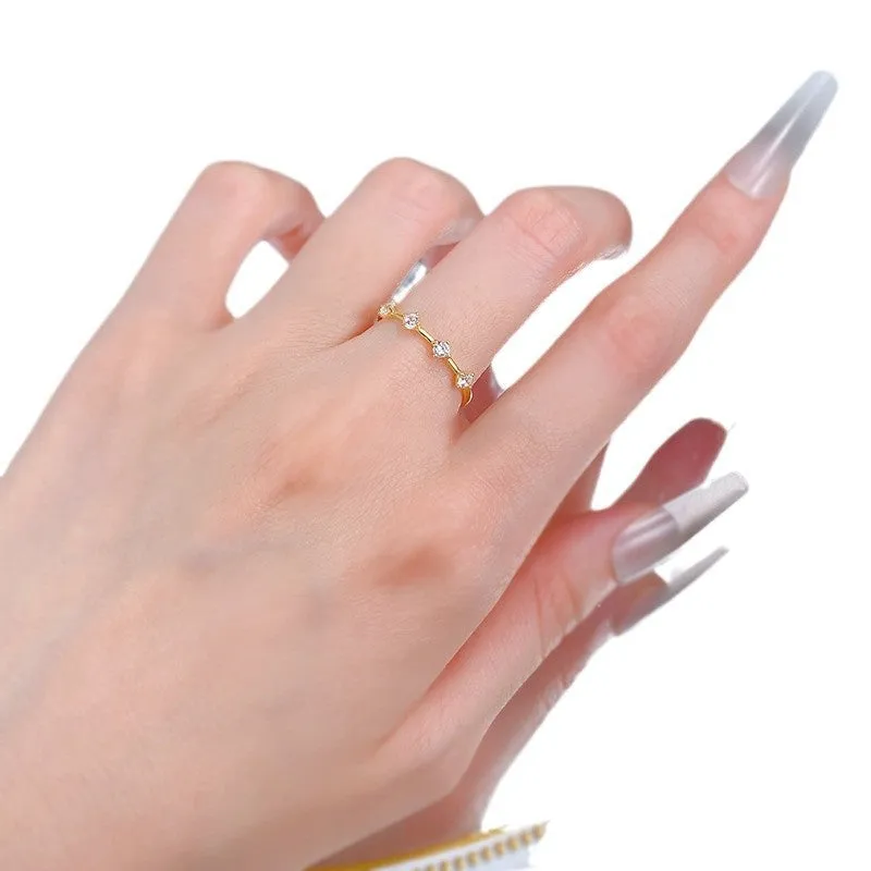 Gold electroplated minimalist ring with a row of small diamonds on silver band