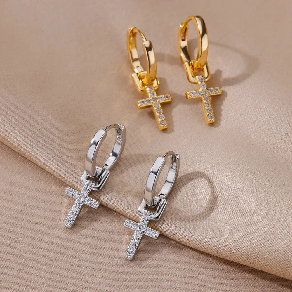 Cross stud earrings with 18K gold plating and clear zircon stone on a white background