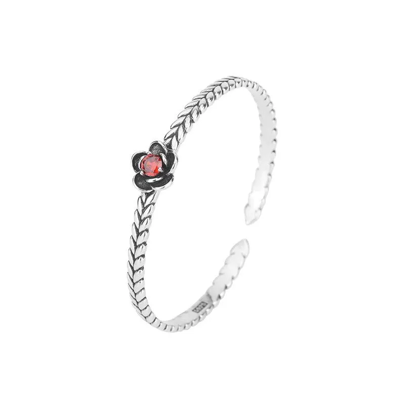 Silver zinc alloy retro bracelet with red zirconium plum flower centrepiece on white background